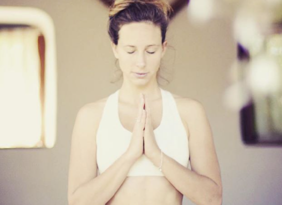 Woman holding her hands in a yoga pose at Radiant Yoga in Marbella