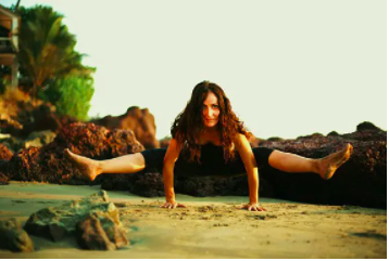 Female Yoga Teach er posing in arm standing yoga position