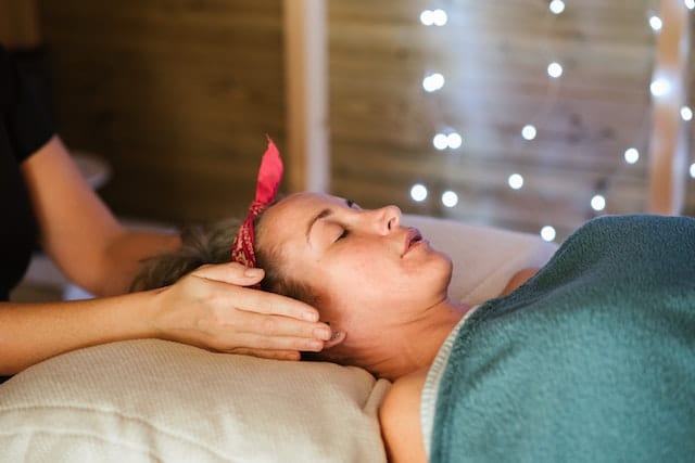 woman lying on massage bed receiving Reiki Healing Massage Marbella