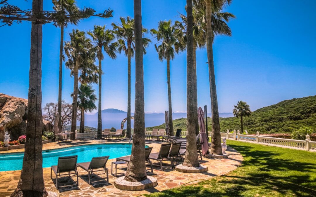 Swimming pool and sun loungers with view of Morocco in distance of a Yoga retreat in Marbella